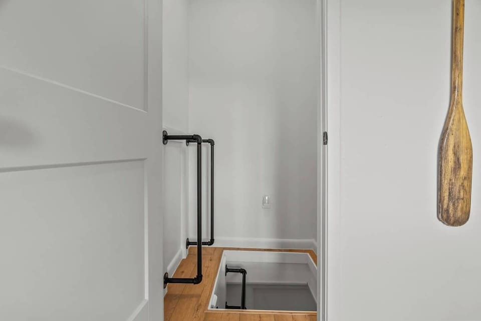 Ladder leading into basement area from dining area.