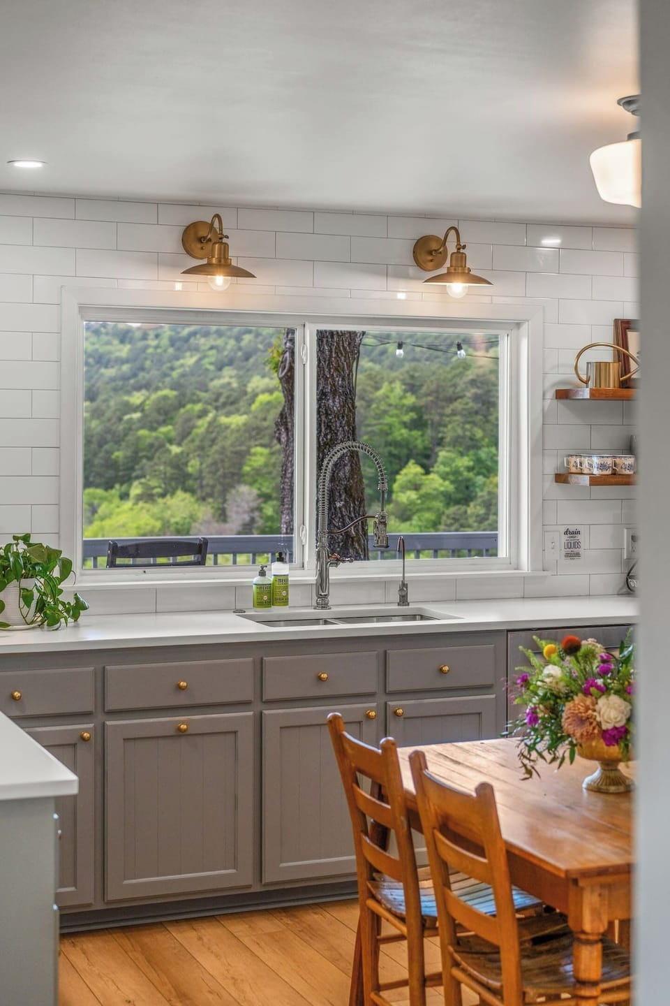 Full kitchen with breakfast table and window overlooking the deck and mountains.