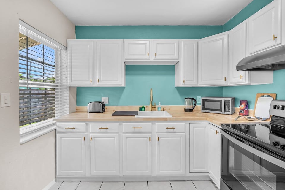 A generously sized kitchen, complete with the essential amenities and ample storage space for your culinary needs.