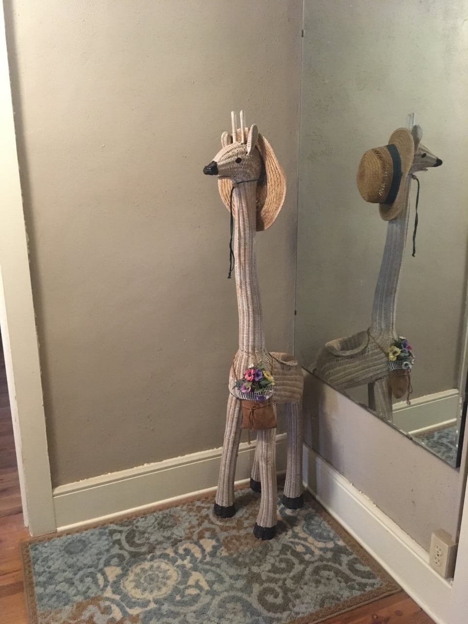 The wicker giraffe watches the hallway.