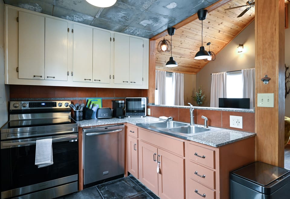 Your fully equipped kitchen awaits with modern appliances and rustic charm for memorable meal preparation together.