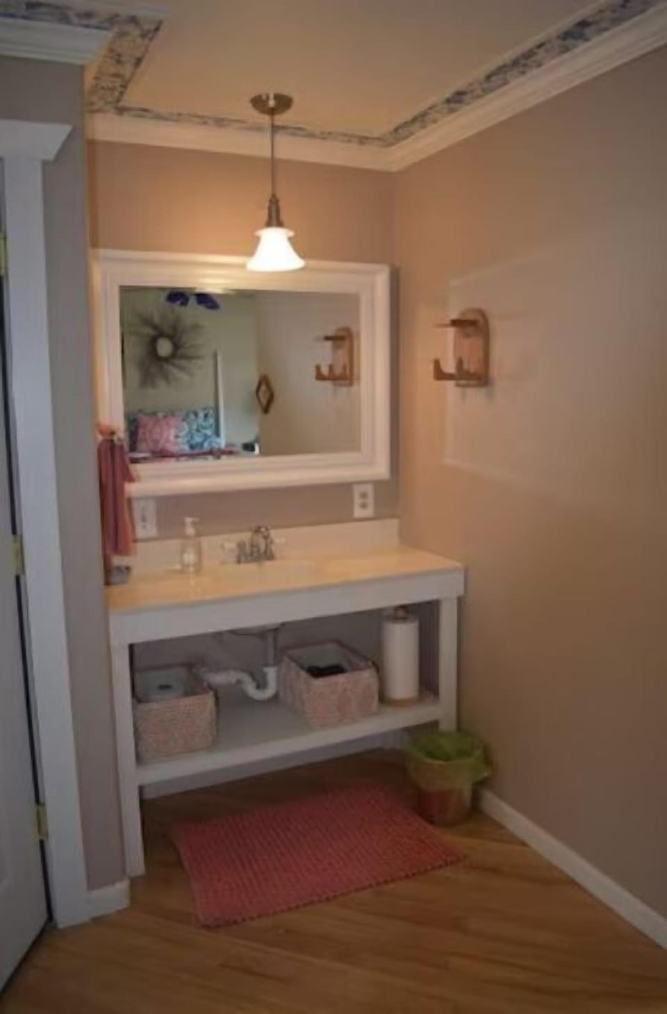 Vanity with one sink located in a nook in the bedroom.