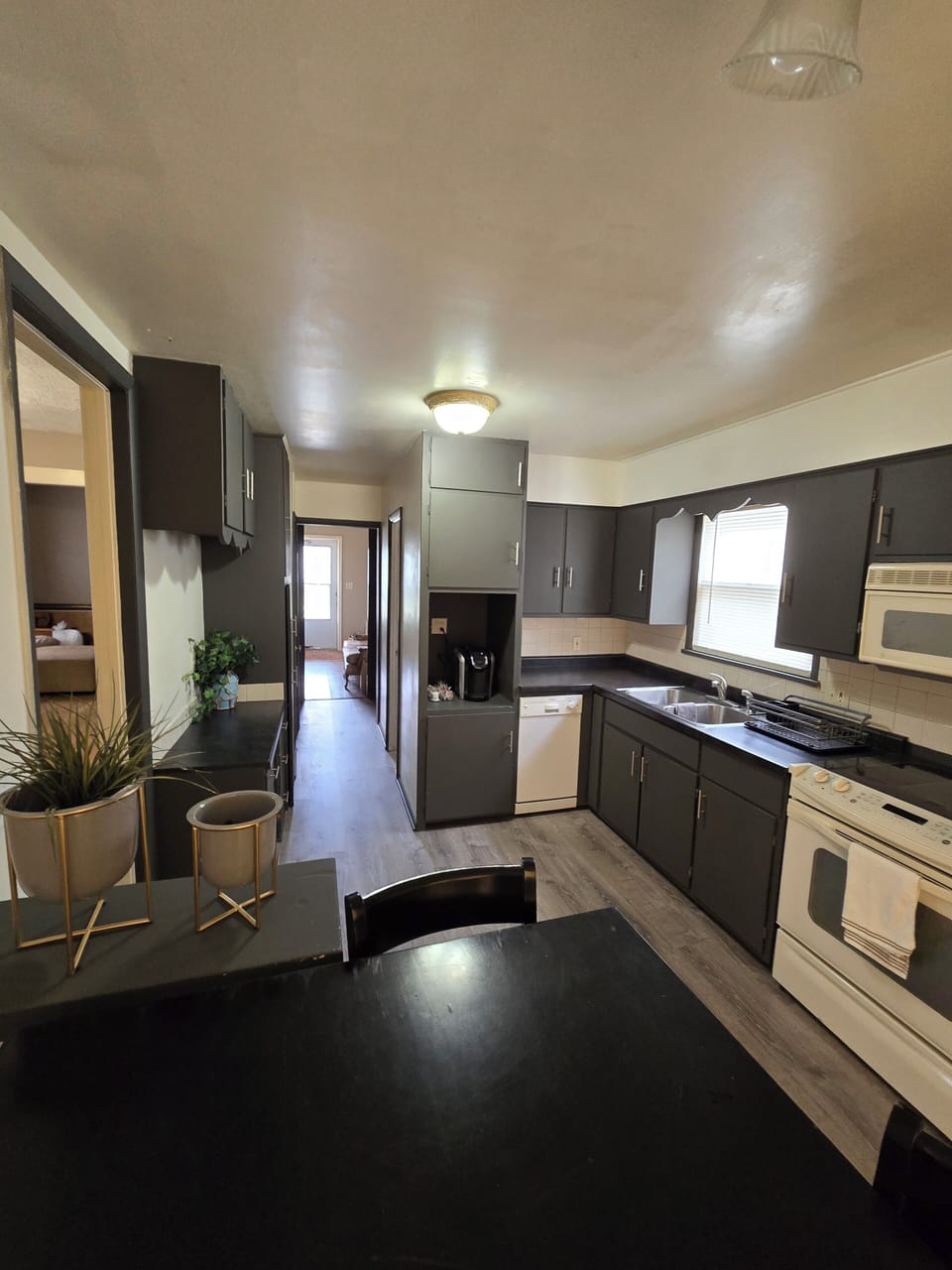 Kitchen  shows access to bathroom, Foyer and Living and Dining rooms