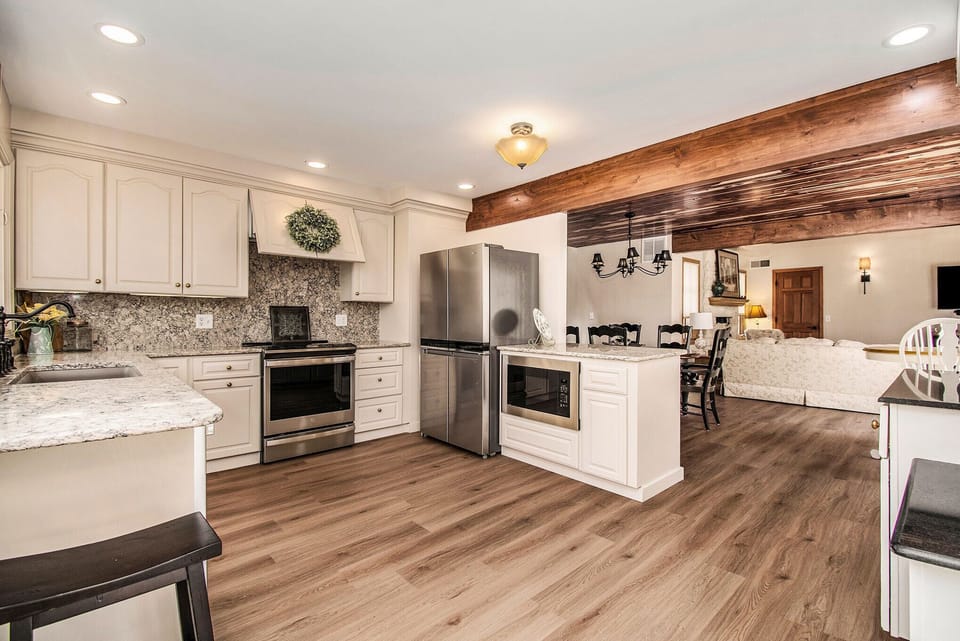 High end kitch, quartz countertops, induction stove, convection oven, microwave.