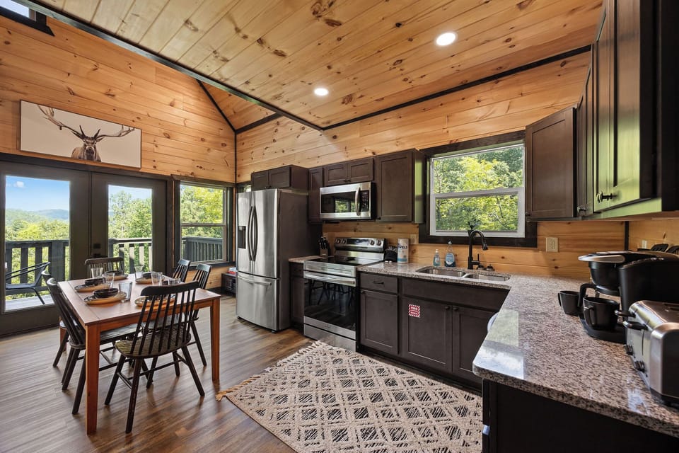 A cozy kitchen and dining nook with plenty of room to gather ‘round. From the farmhouse table to the open concept layout, it’s made for good cookin’ and even better company.