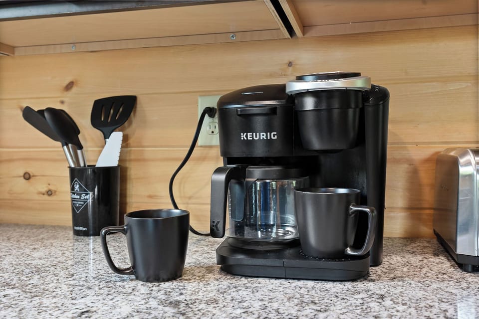 Mornings made easy with fresh coffee, cozy mountain views, and a porch built for sittin’ and chattin’. 