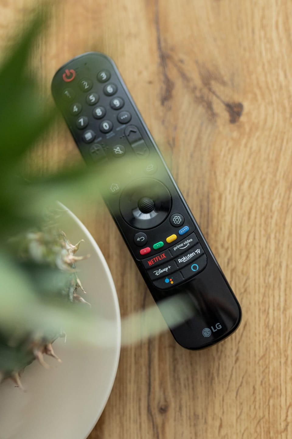 A detailed shot of a TV remote control placed neatly on a surface.

