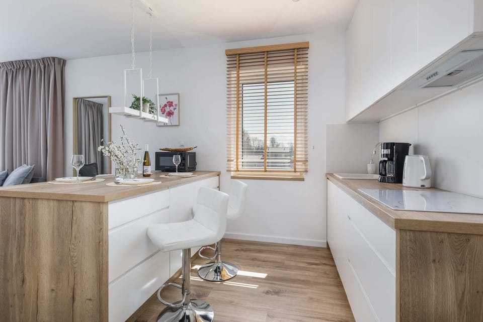 A modern kitchen with all essential appliances and wooden cabinets.