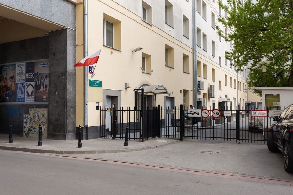 The entrance to the apartment building, highlighting its clean and contemporary design.