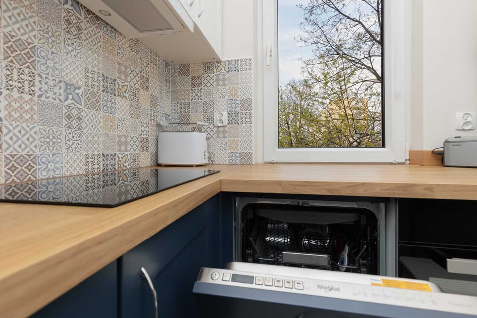 A close-up of the kitchen sink area, highlighting modern finishes and practical amenities.

