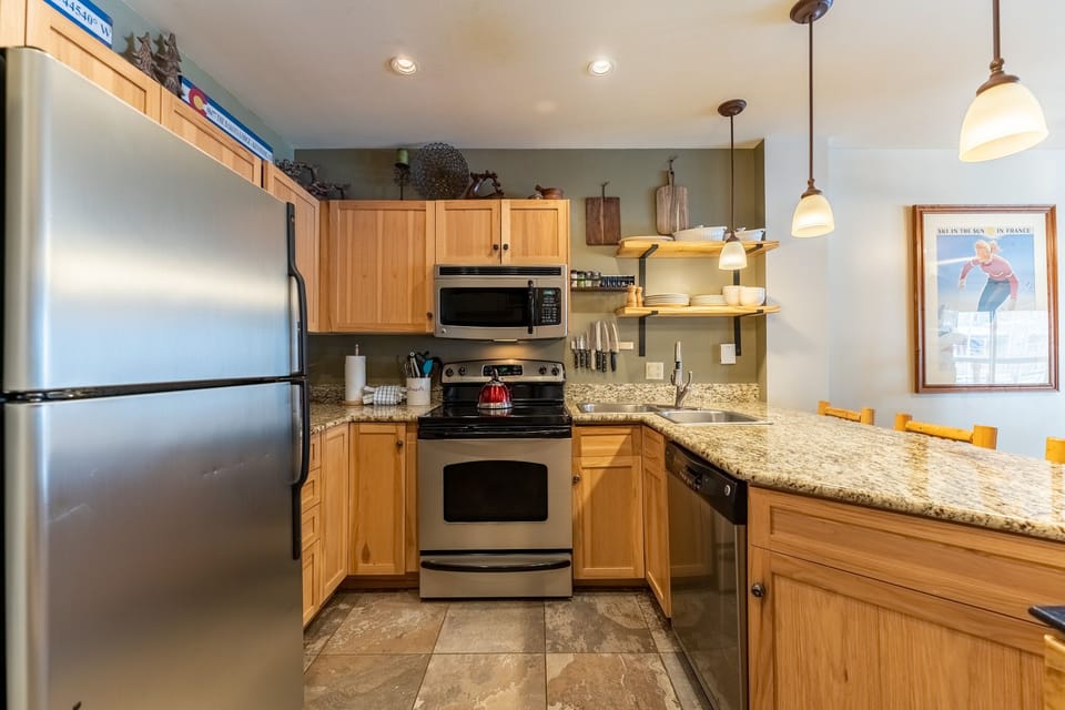 Your spacious kitchen features granite counters, stainless appliances, and warm wood cabinets for memorable home-cooked meals.