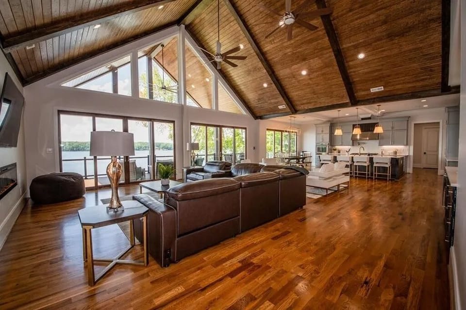 Main level cathedral wood ceiling, leather electric reclining sofa with charging ports.