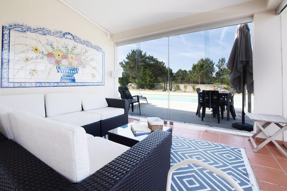 Modern lounge with blue and white furnishings overlooking pool terrace — Villa Terra Mar, luxury holiday villa in Mafra