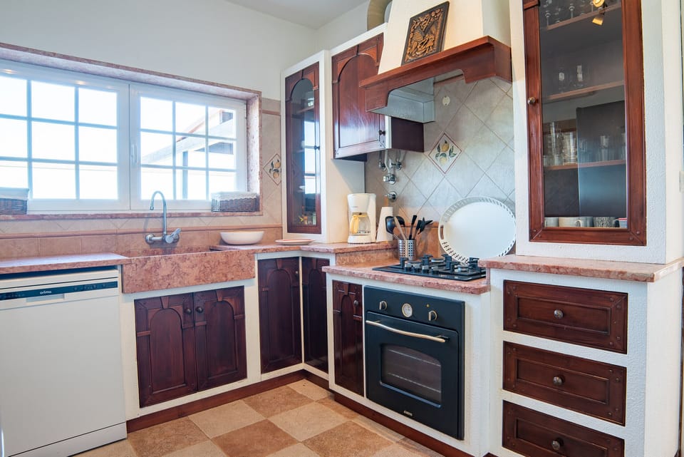 Contemporary kitchen with wooden cabinetry and terracotta countertops — Villa Terra Mar, luxury holiday villa in Mafra