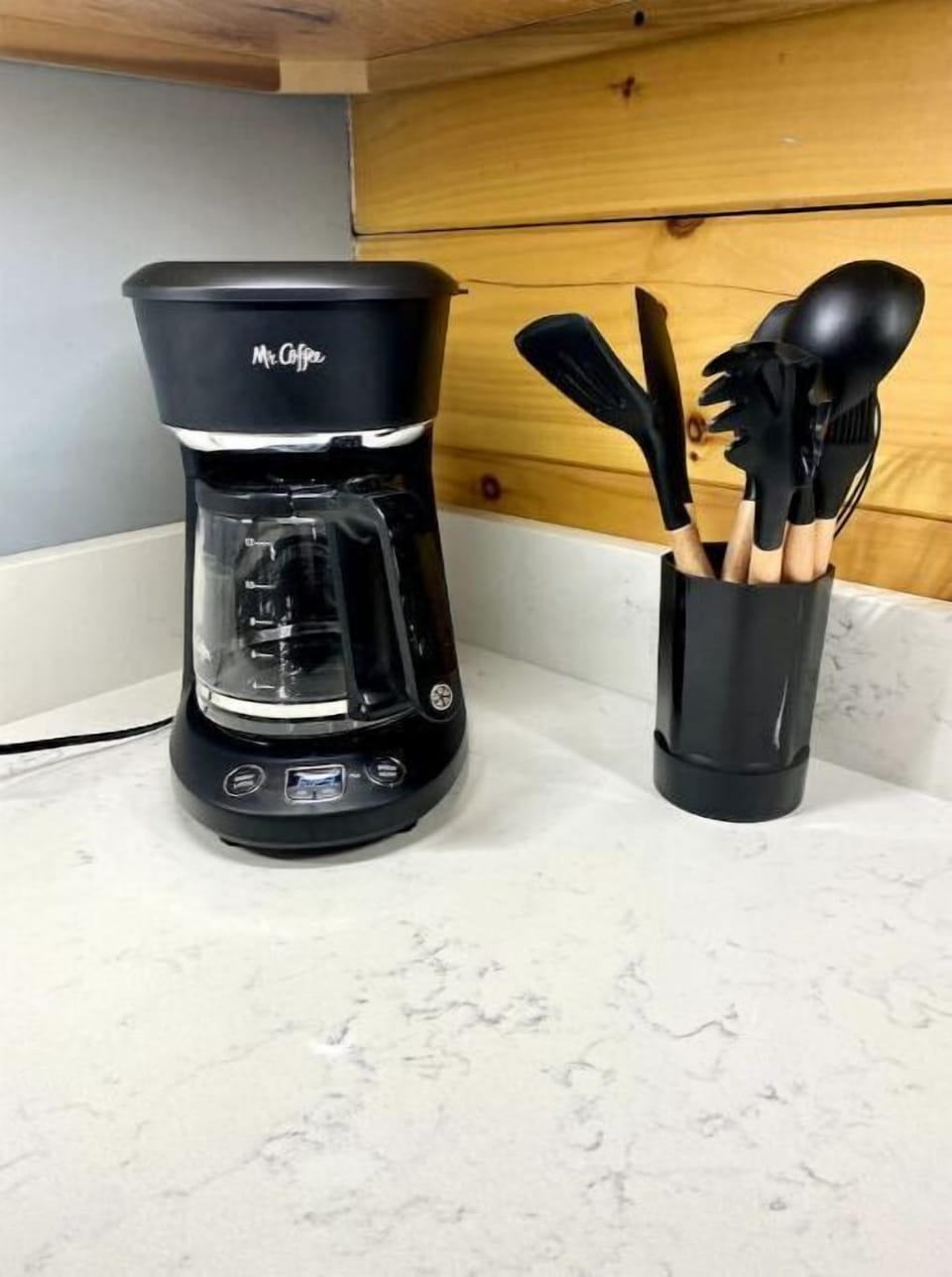 Kitchen is stocked with coffee maker and all the cooking utensils needed.