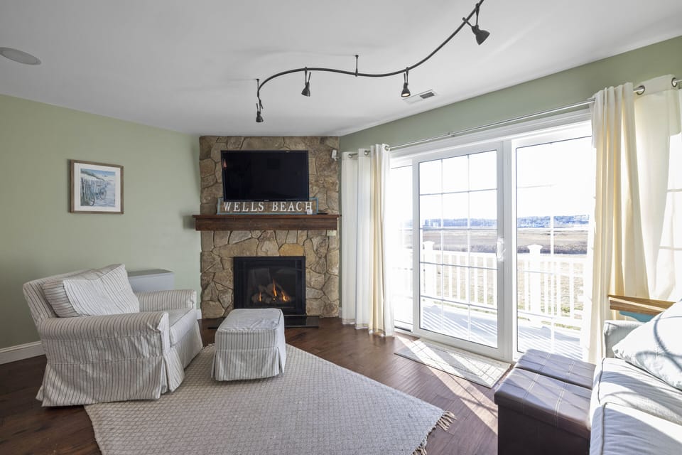 Living room with step out to deck, overlooking marsh
