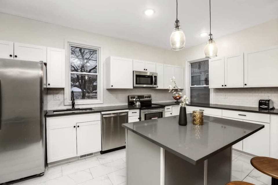 Modern kitchen with island and bar seating.