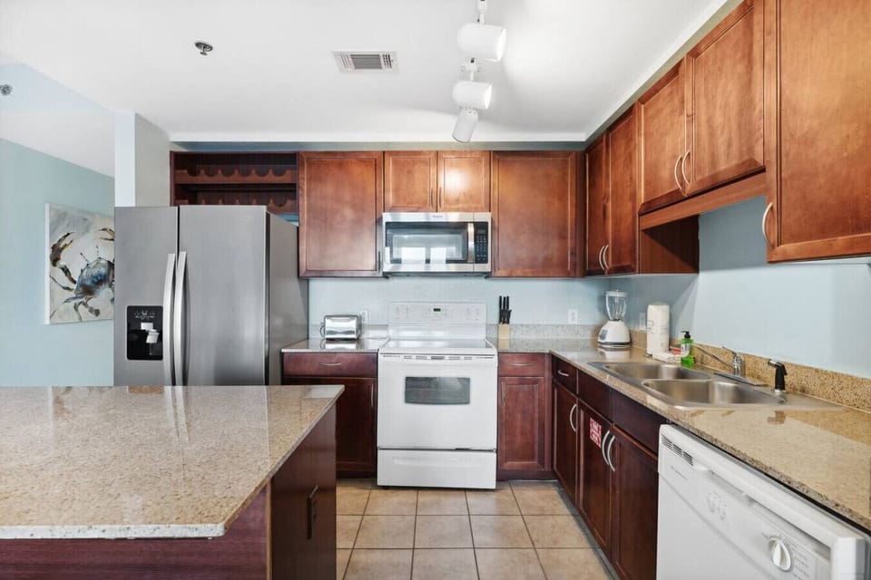 Open Concept, Fully Stocked Kitchen with Drip Coffee Maker and Island Bar Seating