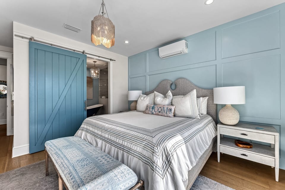 The bedroom flows effortlessly into a bright ensuite, combining comfort with private convenience.