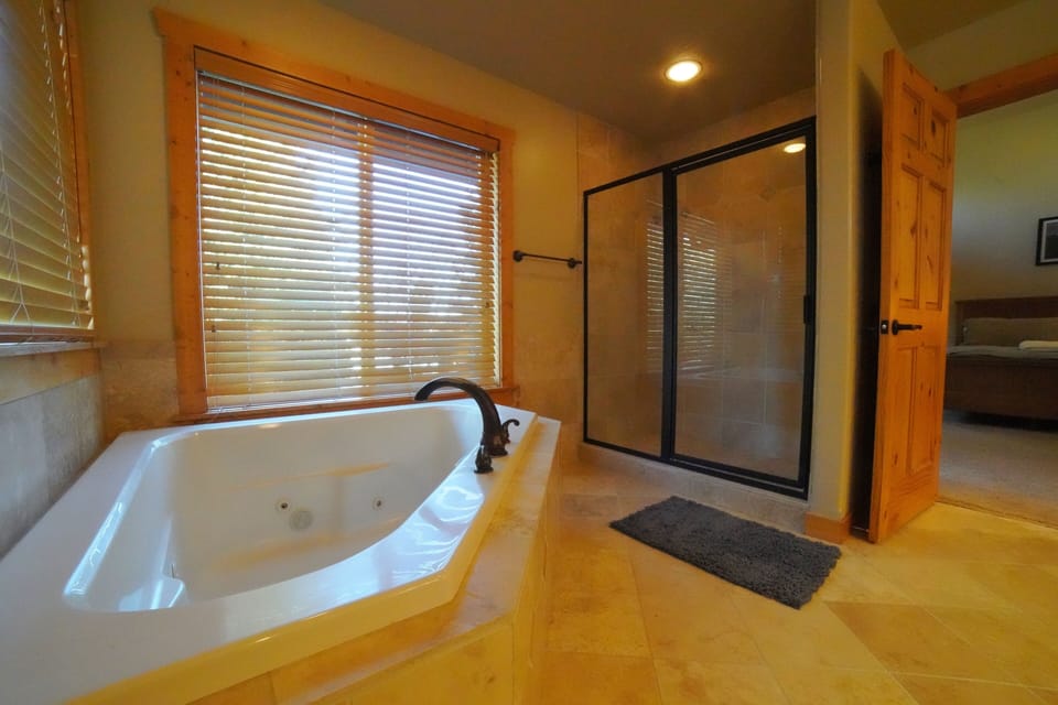 The master en suite has a large double vanity, a soaking tub, and a walk-in shower.
