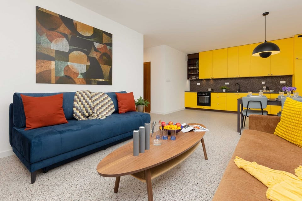 Open-plan living area with two cozy sofas, a coffee table, and a vibrant design, perfect for socializing or relaxing.
