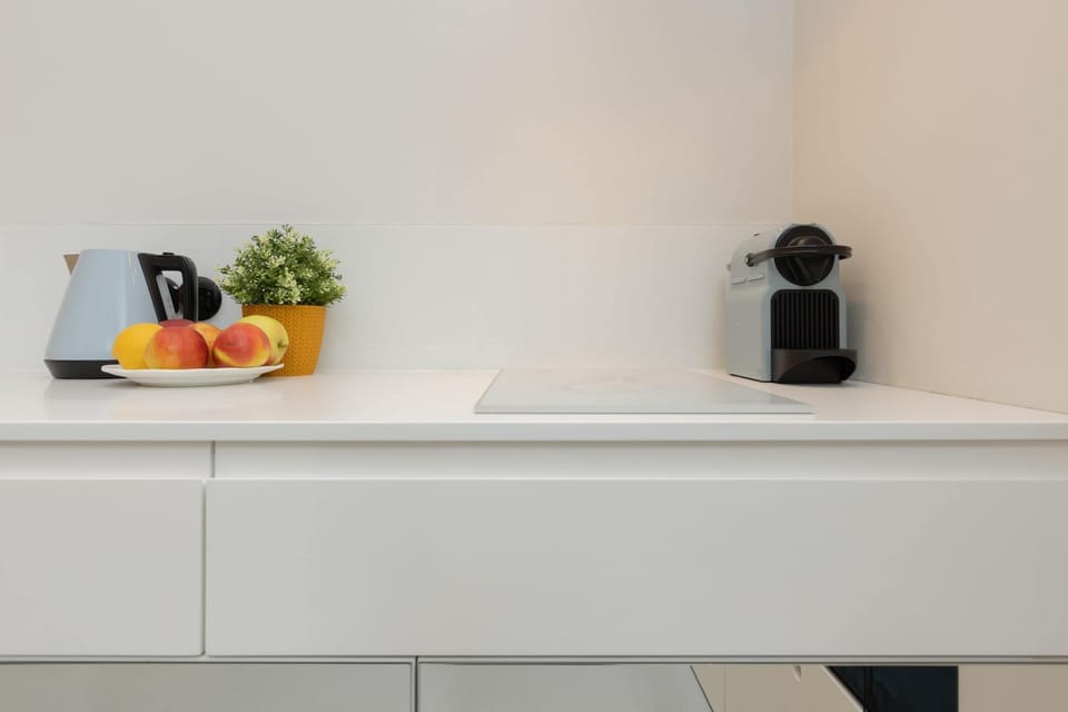 Close-up of a minimalist countertop with a coffee maker, adding a convenient touch for morning routines.
