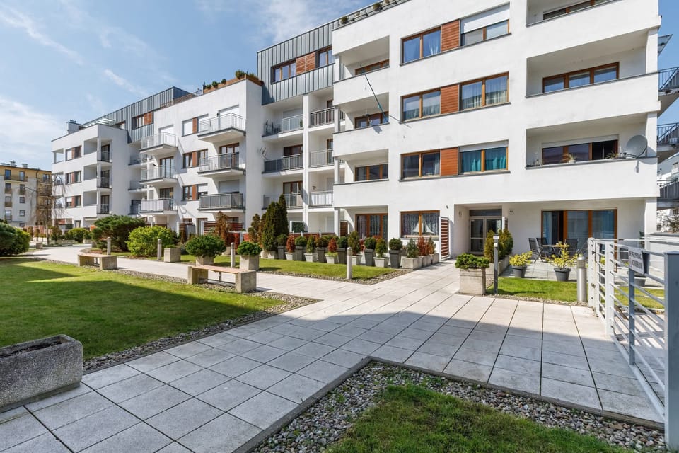 A view of the well-maintained courtyard surrounded by greenery and modern architecture.