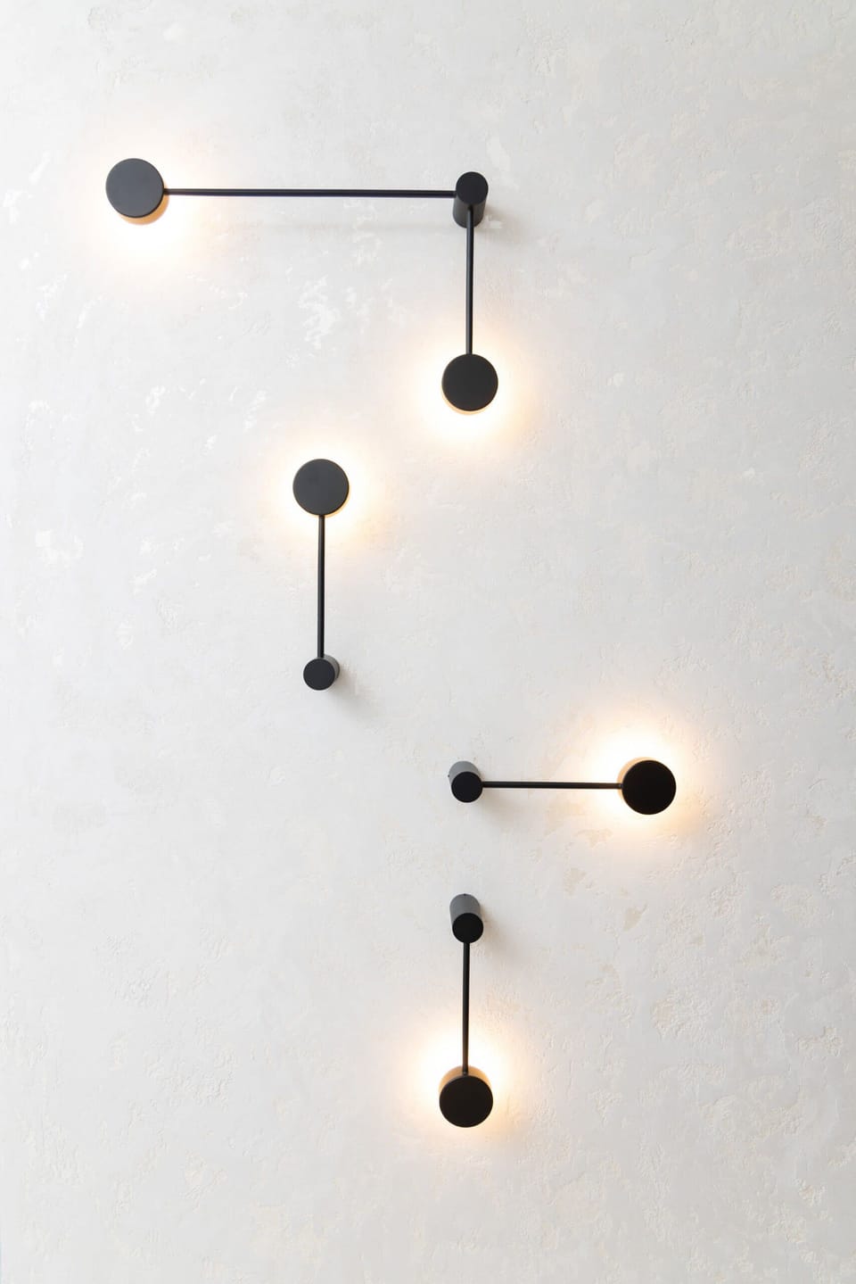 A modern light fixture with a unique design, adding a stylish element to the apartment's interior.

