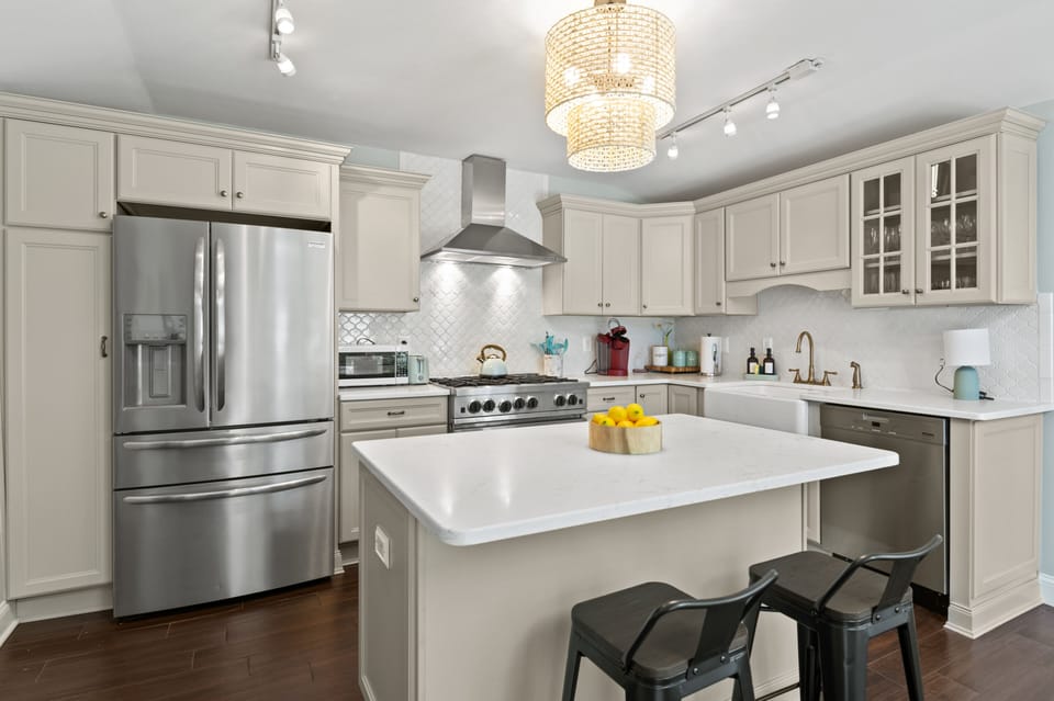 Gourmet kitchen with 6 burner gas stove and full dining and cooking materials.