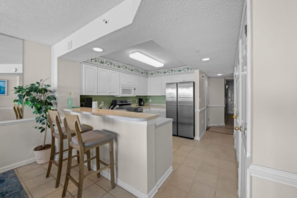 The kitchen counter provides additional  space for serving snacks or meals.