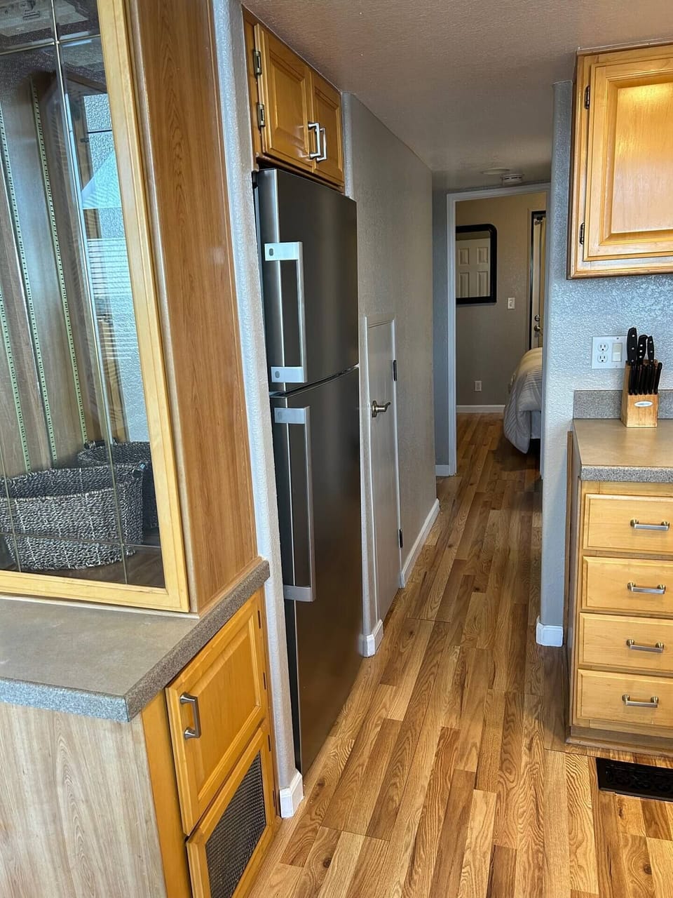 Walkway to Bedroom, Stainless Steel Fridge in Kitchen