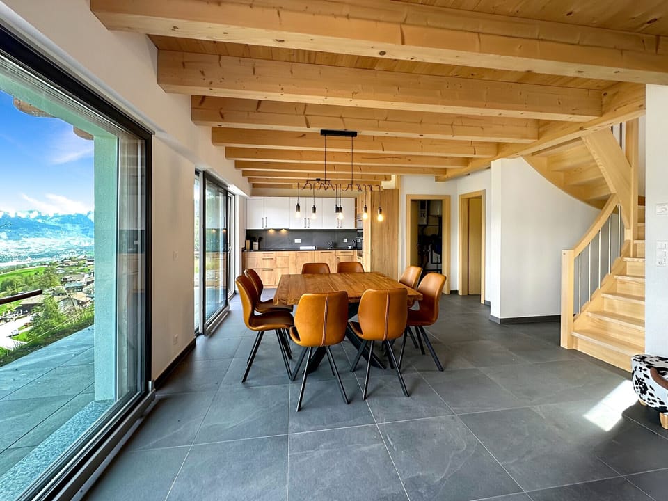View of the open-plan dining room with its large bay windows.