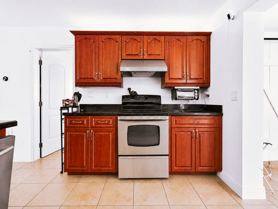 Bright kitchen with rich wood cabinets and stainless steel appliances