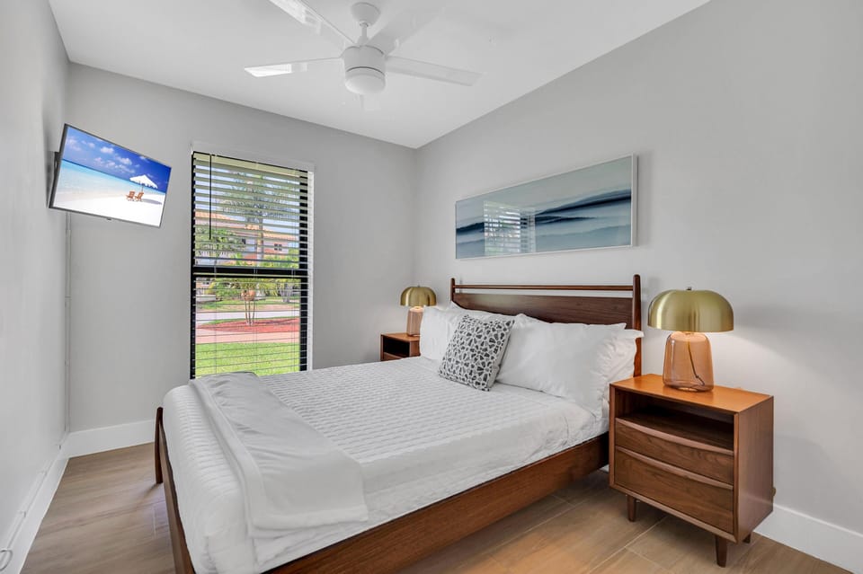 The third guest bedroom also features a queen-sized bed and smart TV.