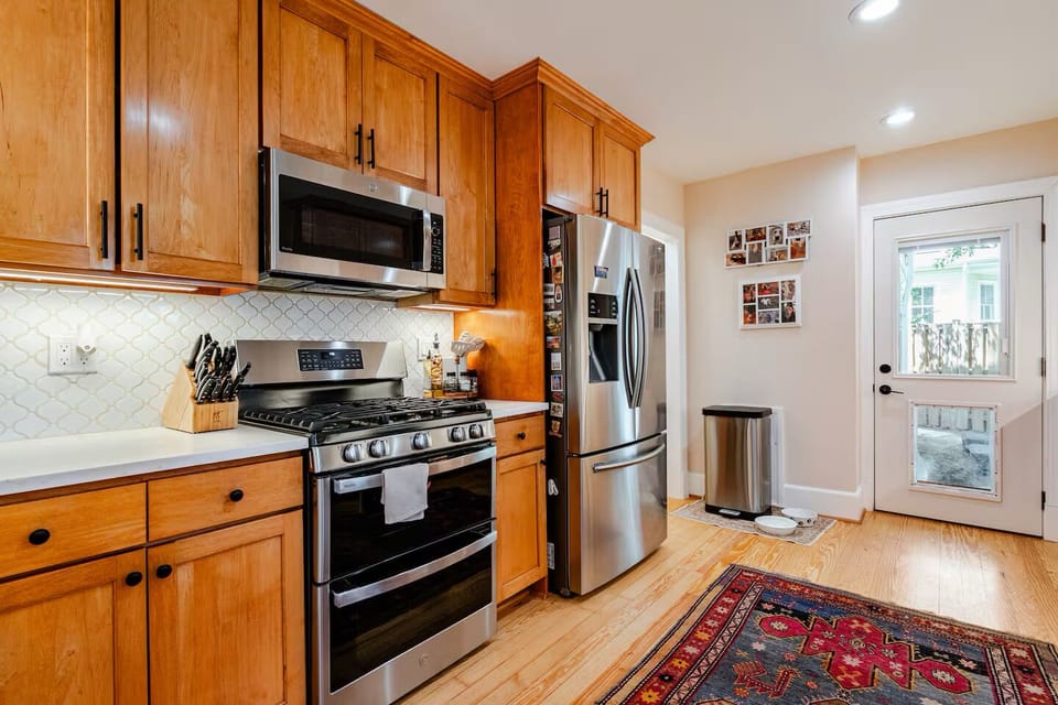 Kitchen with stainless appliances and doggie door 