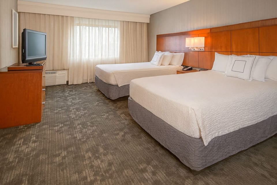 Recharge in a bright double-queen room with crisp linens.