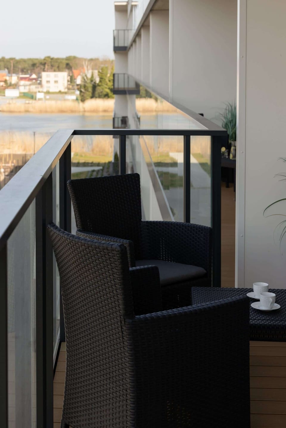 A close-up of the balcony setup, including a table and chairs, perfect for enjoying meals or drinks outdoors.
