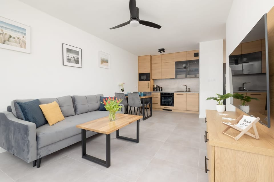 A wide-angle view of the living space, highlighting the open-plan layout that seamlessly connects the kitchen, dining, and lounge areas.
