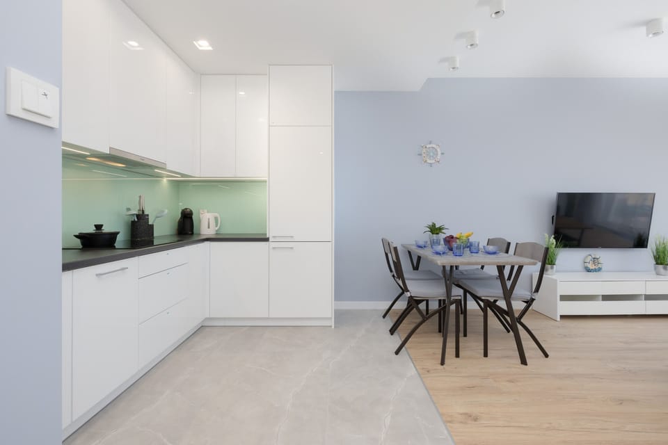Another perspective of the kitchen, showcasing its open-plan layout connecting to the dining and living areas.
