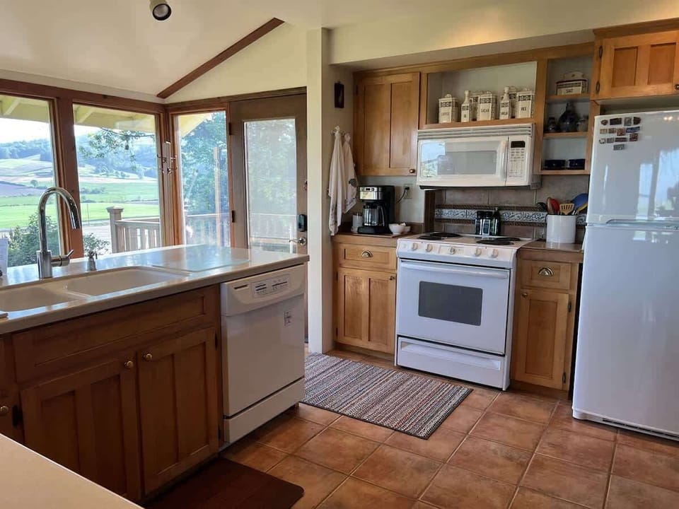 Cook, gather, and dine in this fully equipped kitchen with modern appliances and direct access to the outdoor deck.