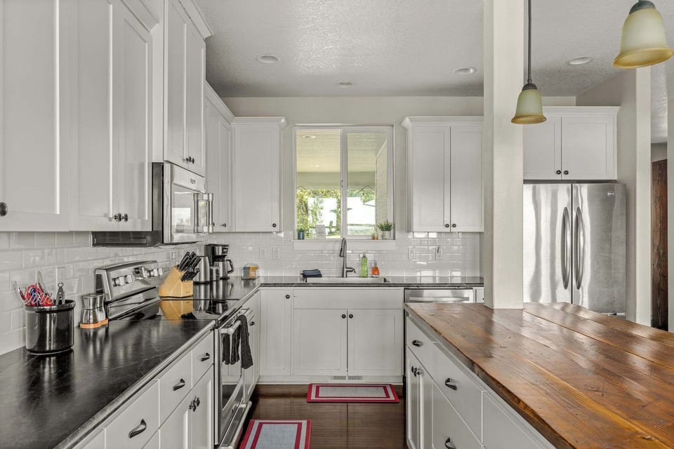 Fully equipped kitchen with stainless appliances, spacious prep areas, and family-friendly functionality.