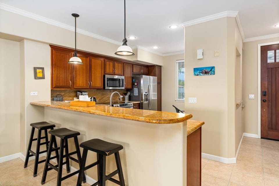 Bar seating for three by the kitchen