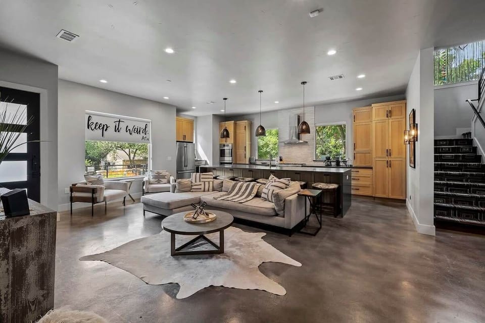Open living room and kitchen with smart. TV and appliances