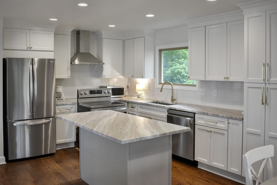Large eat-in kitchen offers new, soft-closed cabinetry and new appliances.