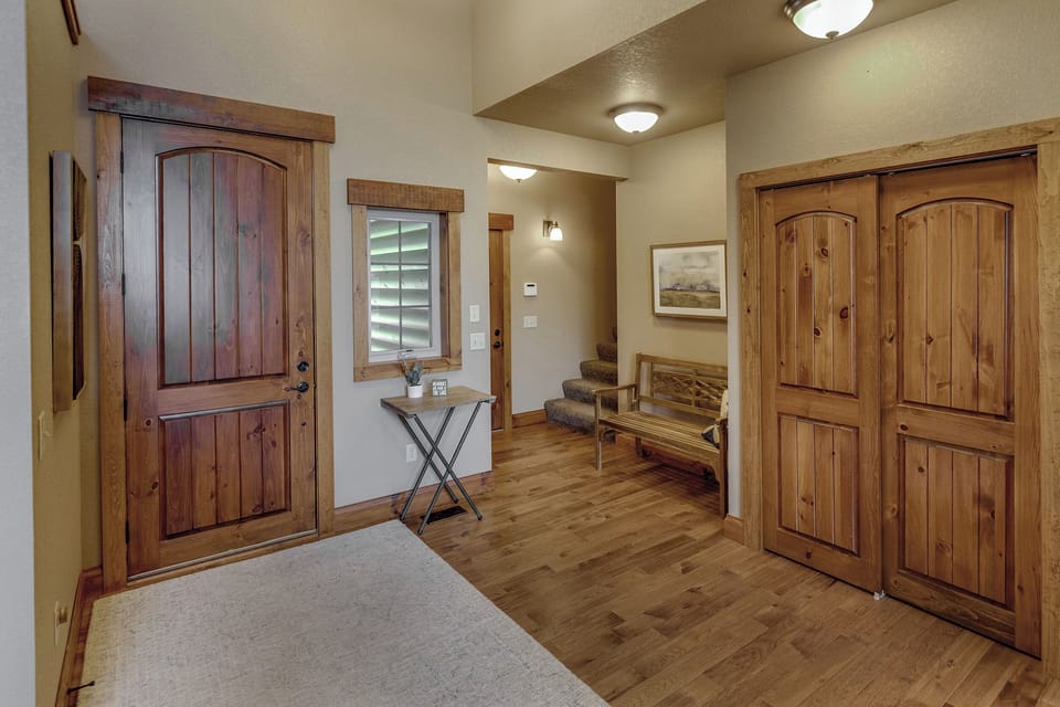 Main floor entrance with staircase to upper level bunk room