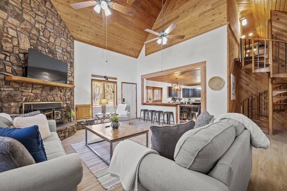 Main Lower Level Living Area showing opening to kitchen and stairs to the second level