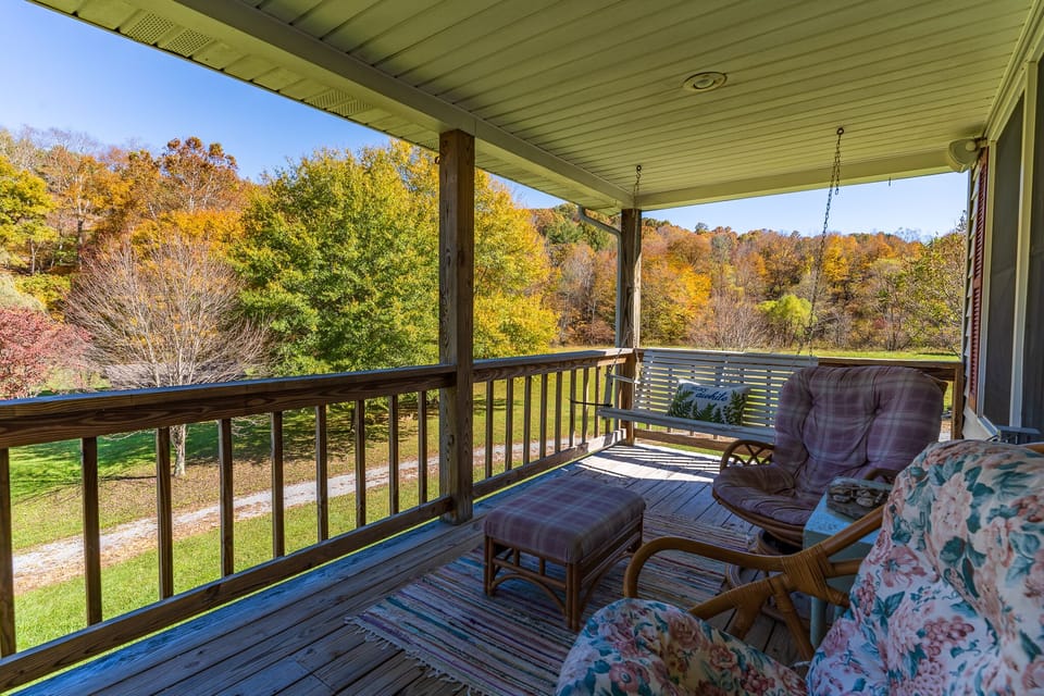 upper level covered porch with views of the creek and property