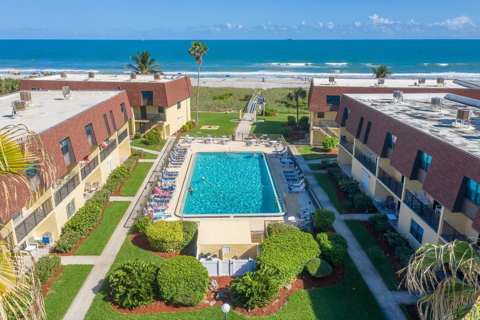 Stunning pool views with lush greenery and ocean in the background.