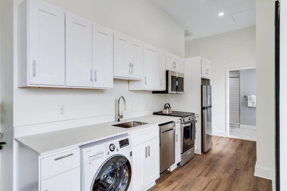 Enjoy making home-cooked meals or getting takeout in this lovely kitchen with stainless steel appliances and a full-size refrigerator