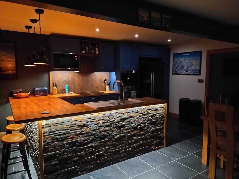 Includes large fridge/freezer with ice dispenser, bar stools, coffee machine